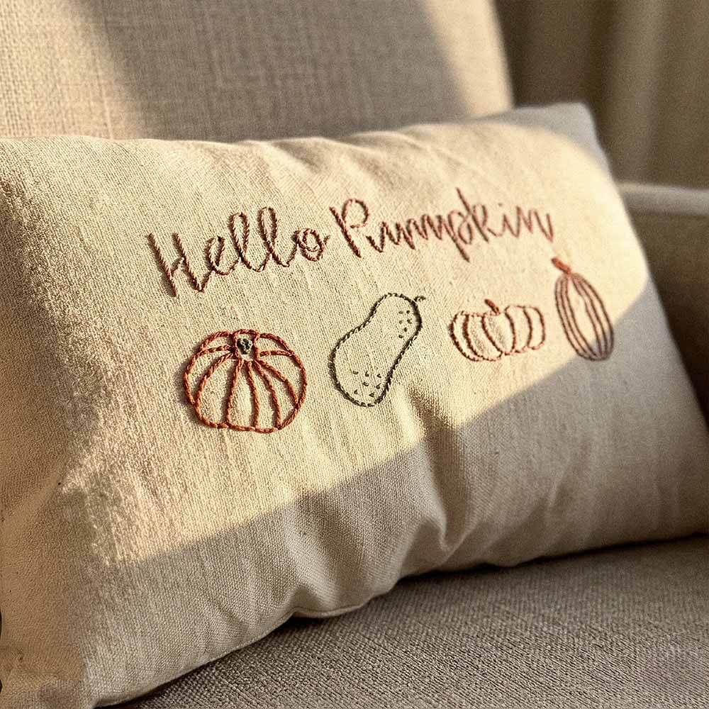 Hello Pumpkin Embroidered Lumbar Pillow | Hand-Stitched Fall Decor | Natural Cotton 3 utumn lumbar pillow Hello Pumpkin embroidery detail showing hand-stitched script in warm rust thread