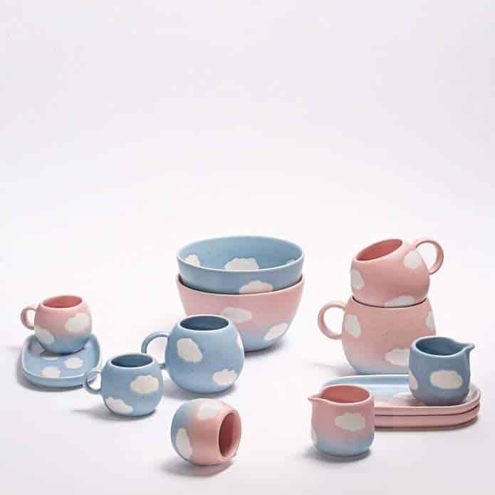 a collection of pink and blue handmade ceramic mugs