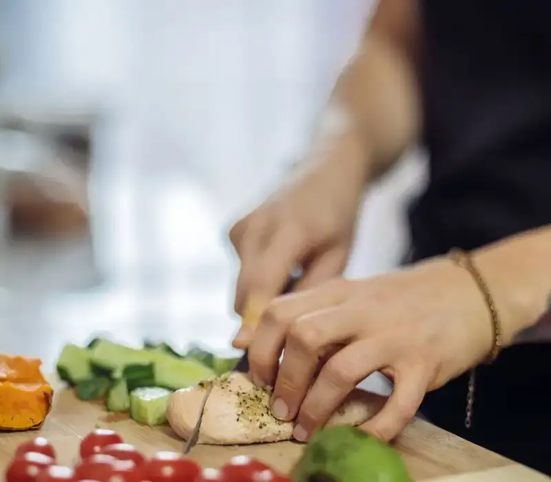 Non Toxic Cutting Boards: Top Picks for a Healthy Kitchen in 2024 6 woman hand prepping and vegetable on wooden cutting board. Best Cutting Boards for Meats