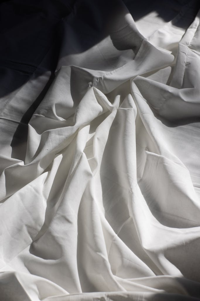 Thread Count Explained: What Really Matters in 2024 2 Draped fabric on bed in sunlight. Eucalyptus sheets vs bamboo