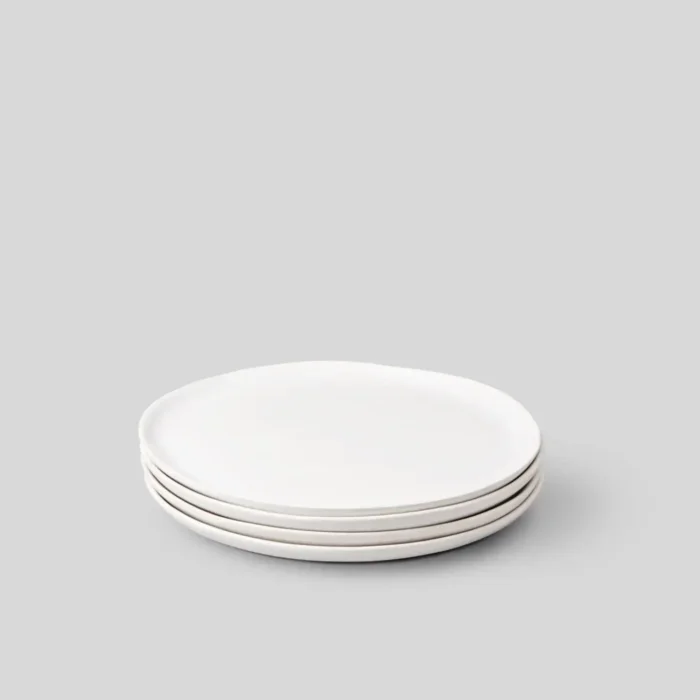 A set of four white Fable Small Salad Plates stacked neatly on a plain background.