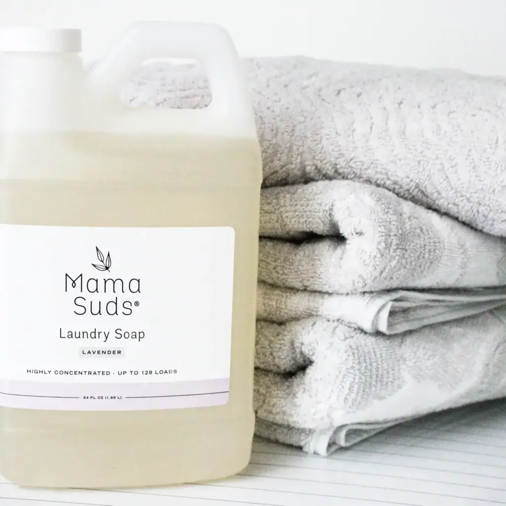 How To Care For Your Organic Cotton Duvet 4 MamaSuds Laundry Soap (Unscented) on the side of a pile of duvet
