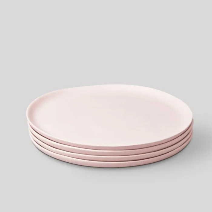 A complete set of Fable Dinner Plates in blush pink, showcasing their elegant, modern design. Perfect for both everyday meals and special occasions, these plates combine style with functionality.