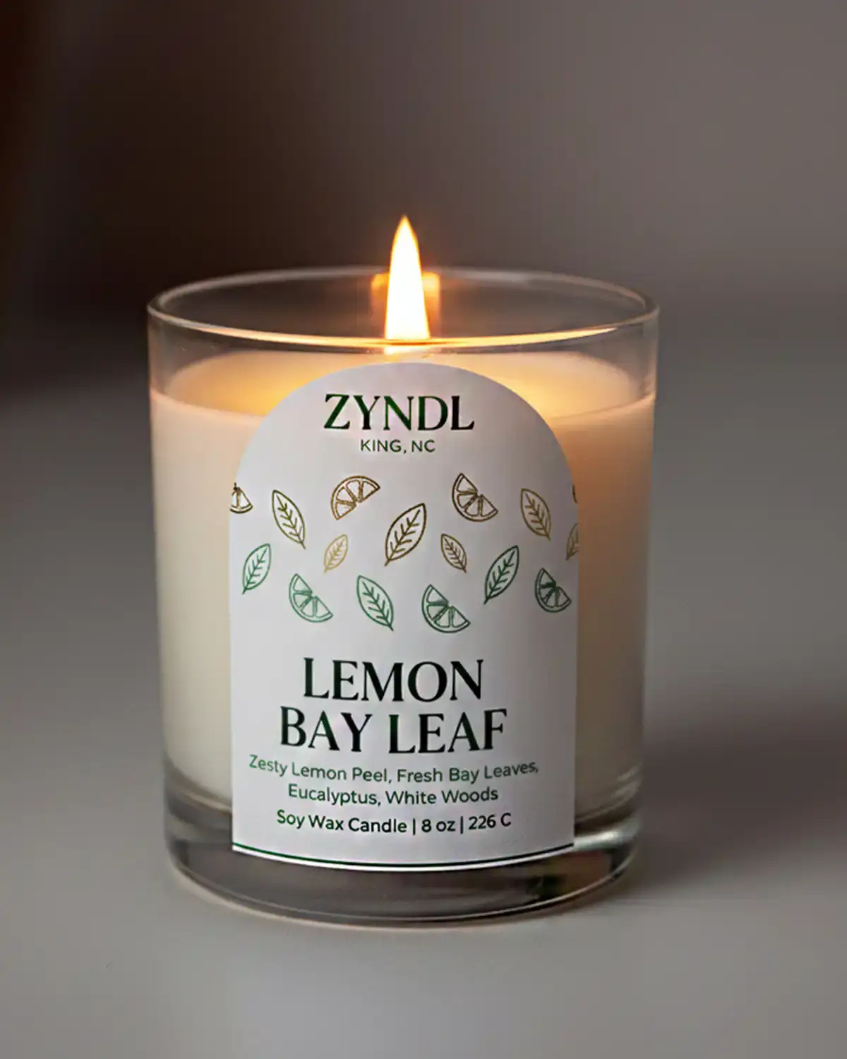 How to Fix Candle Tunneling & Make Your Candles Burn Evenly 1 fix candle tunneling. lit lemon bay leaf candle on white background.