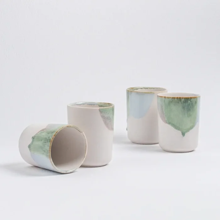 Four Douro Cups by Egg Back Home arranged on a white surface, displaying their elegant design and colorful glaze.
