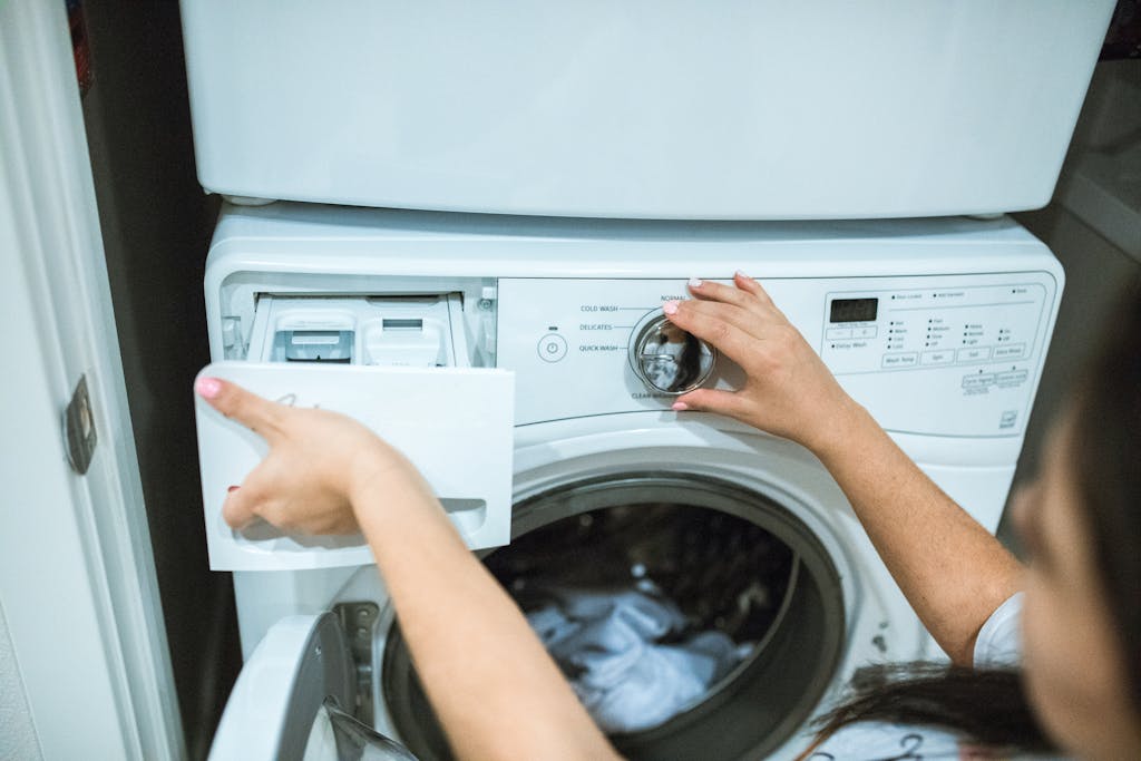 How To Care For Your Organic Cotton Duvet 3 A Person Holding White Front Load Washing Machine