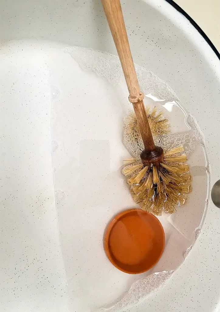 How to Keep Your Toilet Brush Clean 3 Toilet Cleaning Brush submerged in hydrogen peroxide and water mixture
