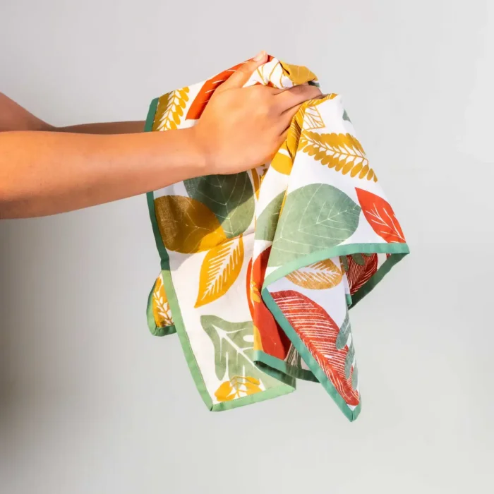 hands holding natural print dish cloth