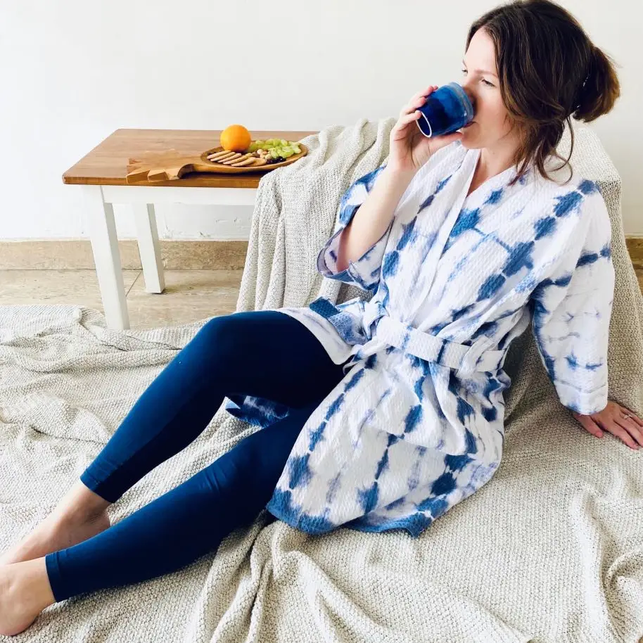 Cotton Tie Dye Shibori Robe by Ziyada 3 a woman on a bed wearing waffle cotton robe. shibori robe