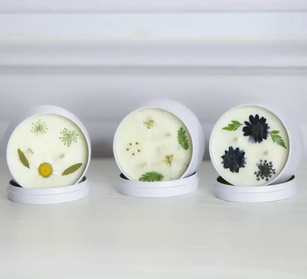 Seasonal Scents: How to Match Your Home to the Time of Year 2 3 floral tin candles in a row
