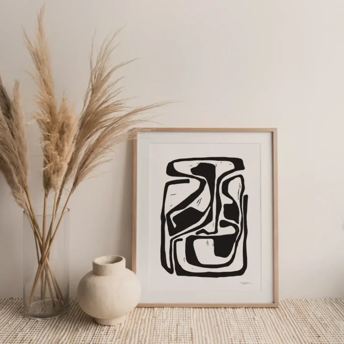 Bauhaus art print in a wooden frame, displayed on a neutral background with pampas grass.