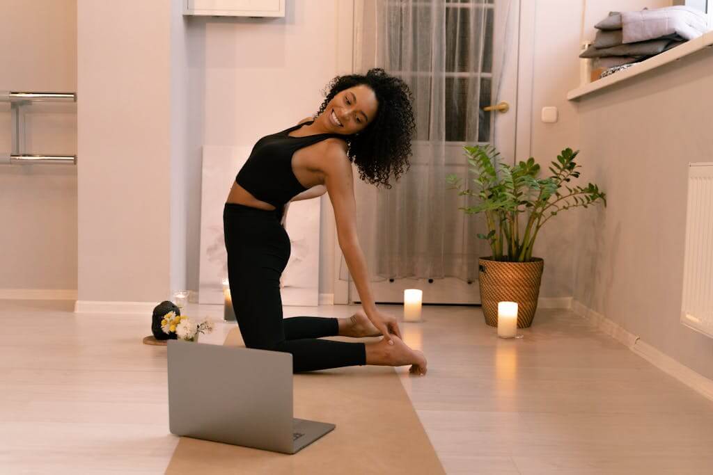 Setting Up Your Perfect Home Yoga Studio: Essential Tips and Must-Have Items 2 Flexible Woman Doing Stretching surrounded by non toxic candles for a warm and cozy atmosphere