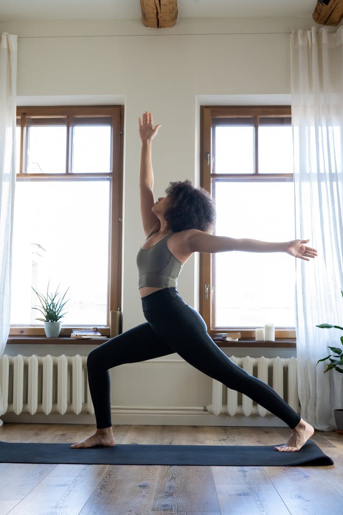 Setting Up Your Perfect Home Yoga Studio: Essential Tips and Must-Have Items 3 woman with afro hair, in her apartment yoga studio