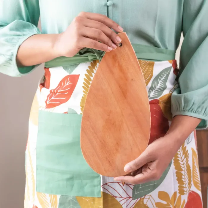 woman holding neem wood chopping board