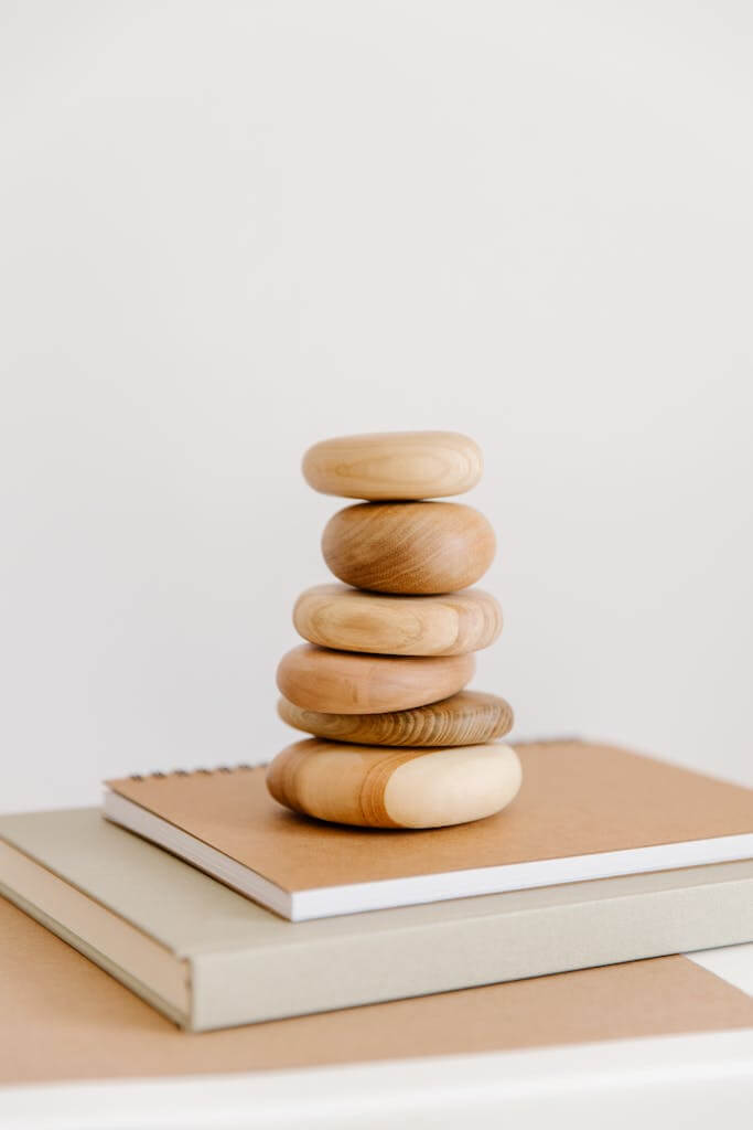 Kensho and Satori: The Secrets of Zen Enlightenment 2 Stack of Round Polished Wood Chunks and Beige Notebooks. Kensho and Satori