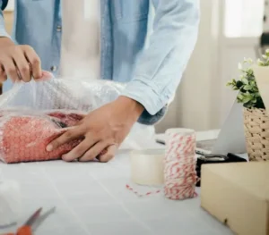 A photo demonstrating how to wrap a glass or stemware with bubble wrap