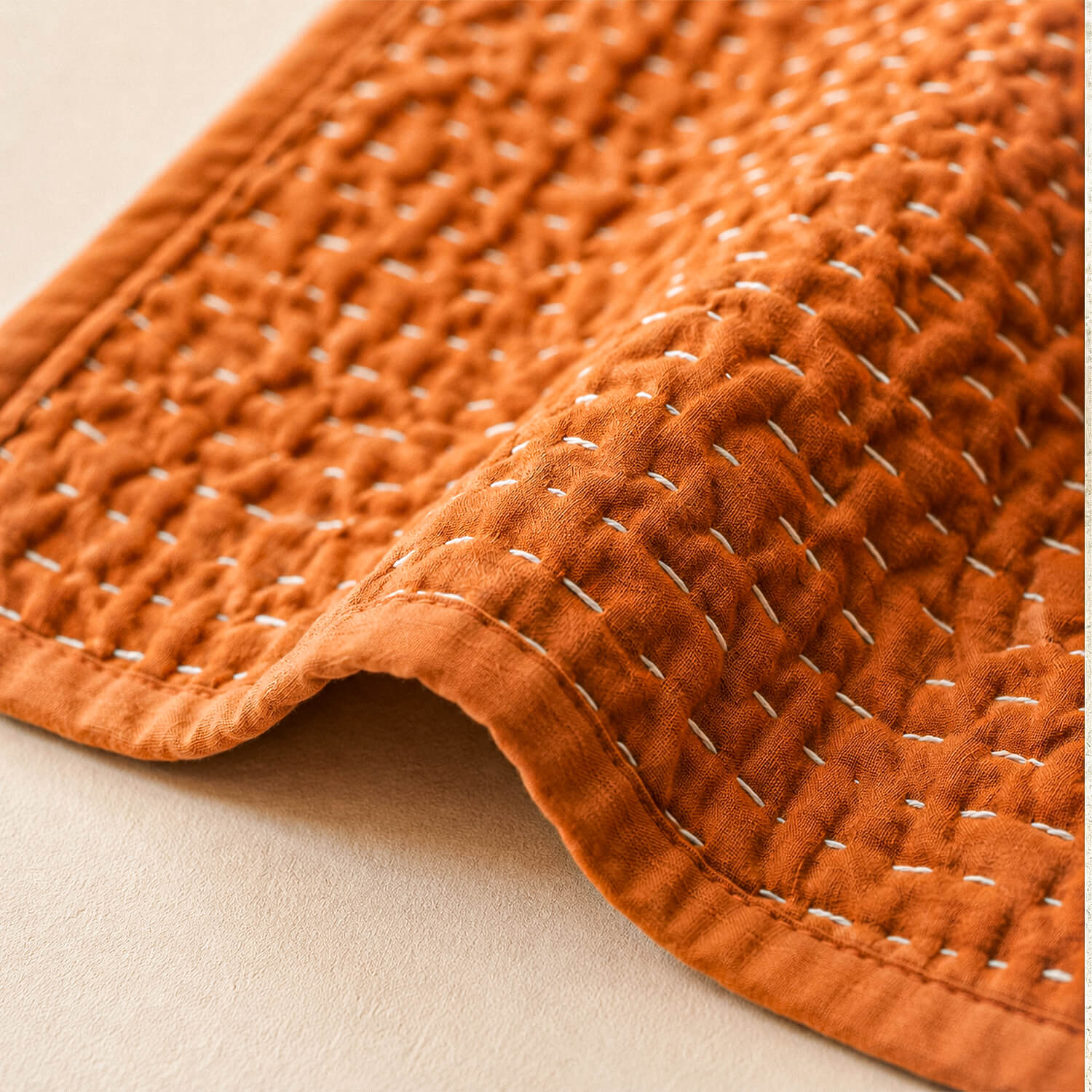 Terracotta Kantha Throw Blanket | 100% Cotton 4 Close-up of rust quilted throw blanket showing detailed Kantha stitching